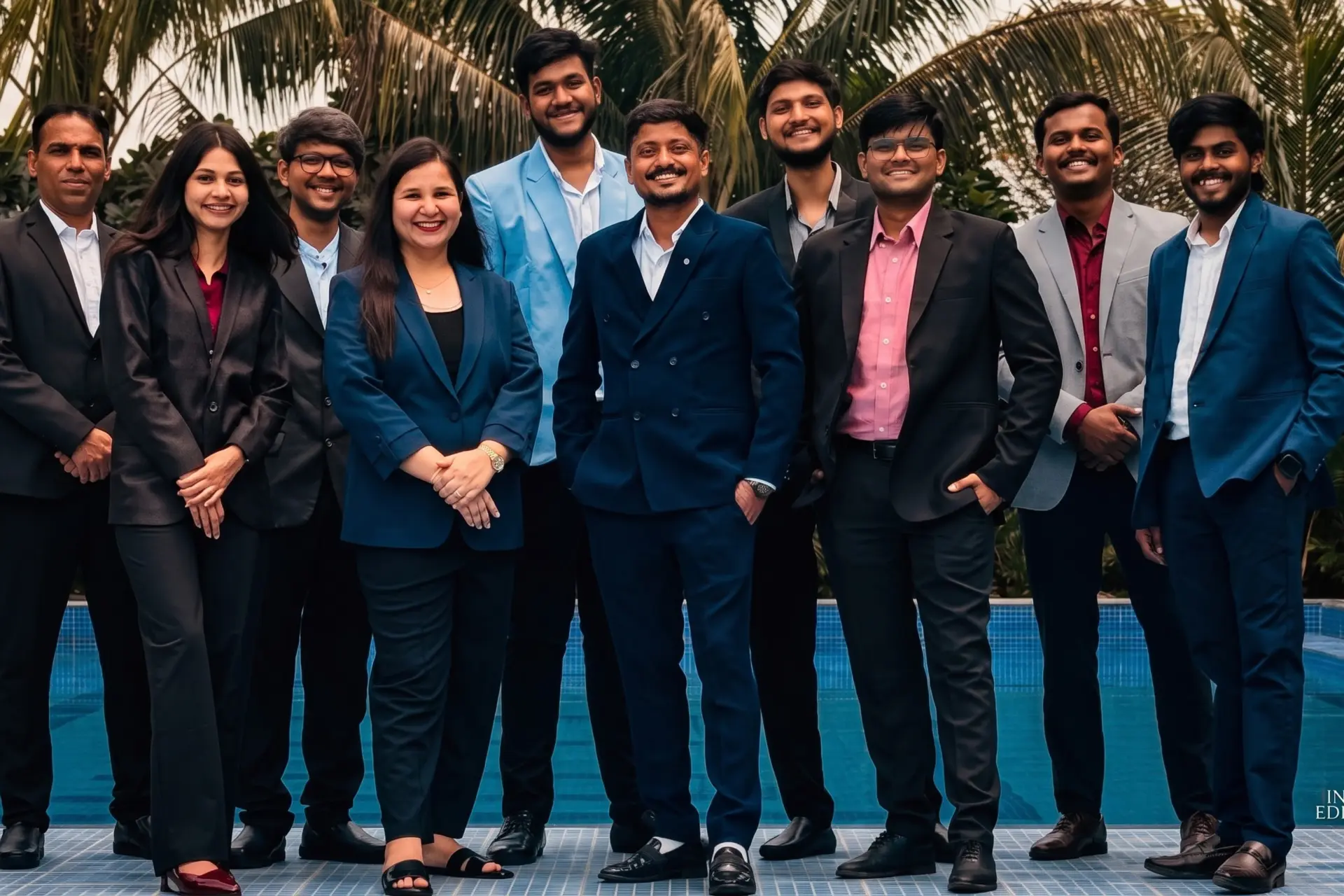 The Xcelerate Advisory team together outdoors by a pool